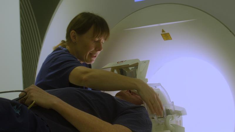 Juliet Semple working in front of a MRI machine